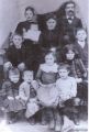 Top row left to right: Elizabeth Walker Reynolds holding baby Charles-Anna Catherine and Joseph C. Reynolds.
2nd row left to right: Walter in front of mother Elizabeth Walker Reynolds-George B. in front of father Joseph C. Reynolds.
3rd row left to right: Edith-Wilson-Laura-Herbert and Mary